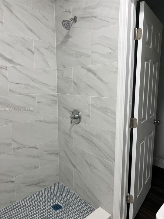 Bathroom shower with marbalized tile