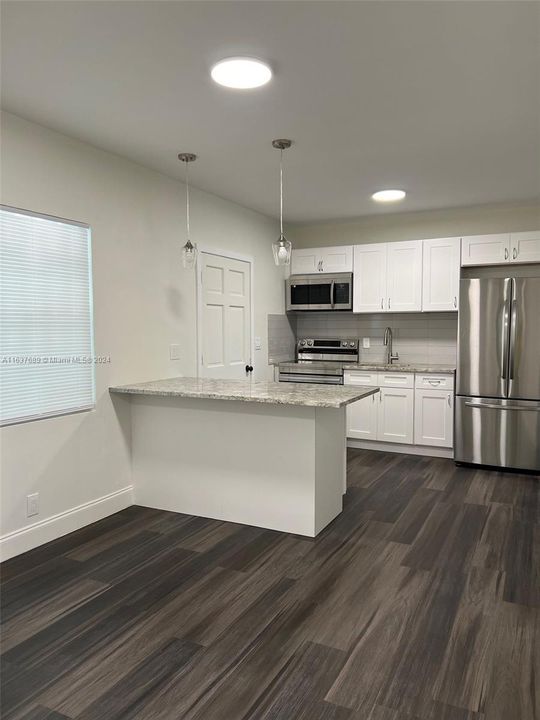 Kitchen and dining area with rear side door.