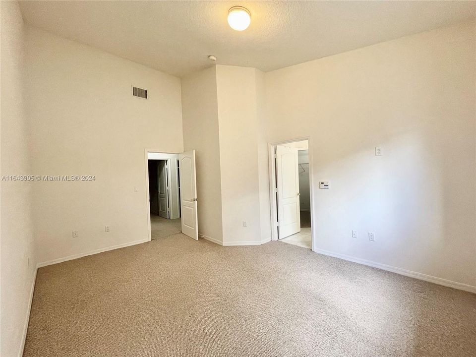 Primary bedroom featuring Extra High ceilings with decline.