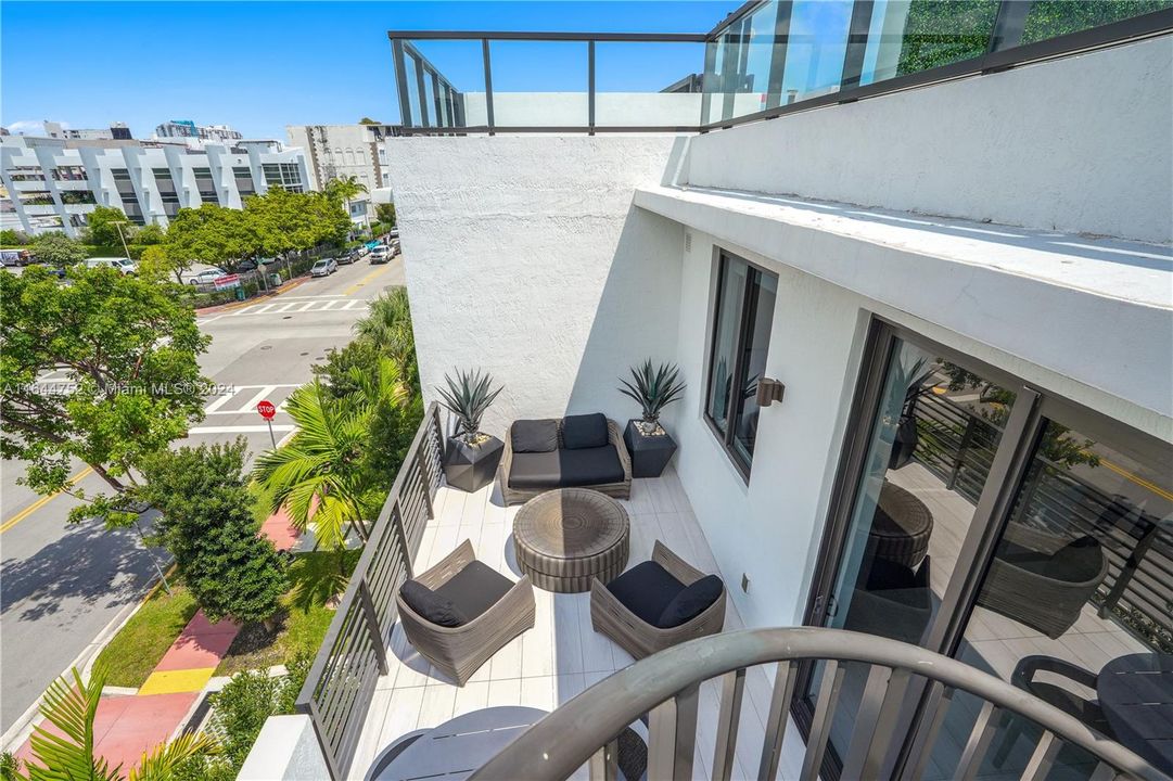 Balcony with staircase access to private rooftop terrace