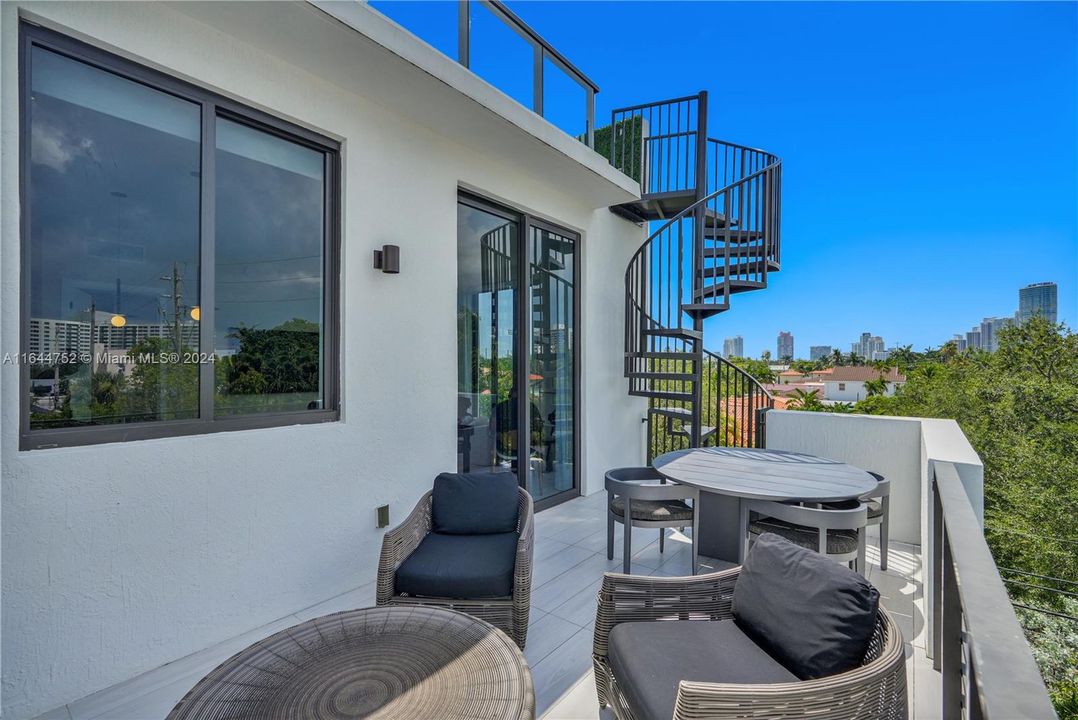 Balcony with staircase access to private rooftop terrace