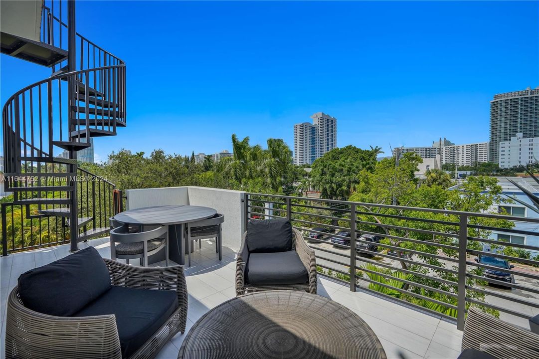 Balcony with staircase access to private rooftop terrace