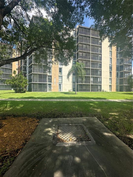 VIEW OF BLDG. FROM SIDEWALK ON CC DR.