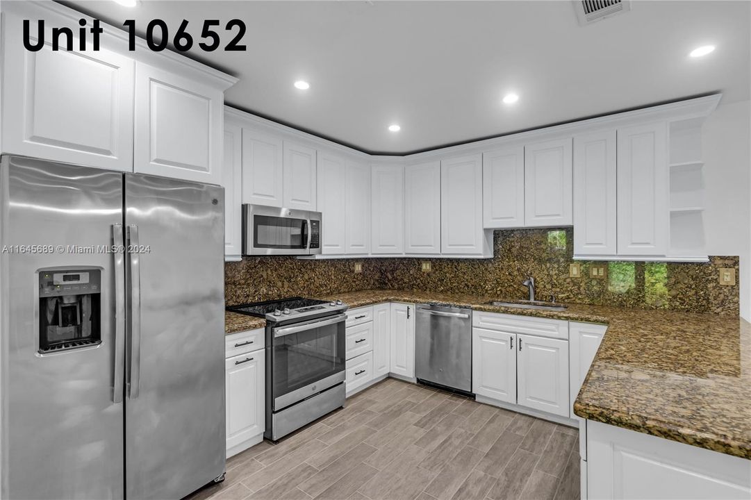 Newer SS appliances, wood cabinets & granite countertops