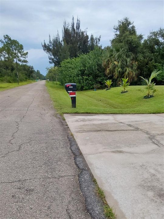 The property faces an asphalt road , not just a path.