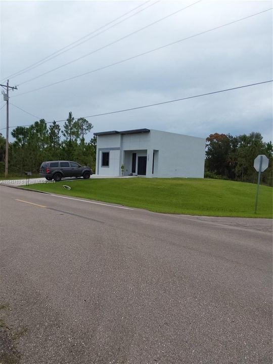 There is a home located across the street, on the corner.