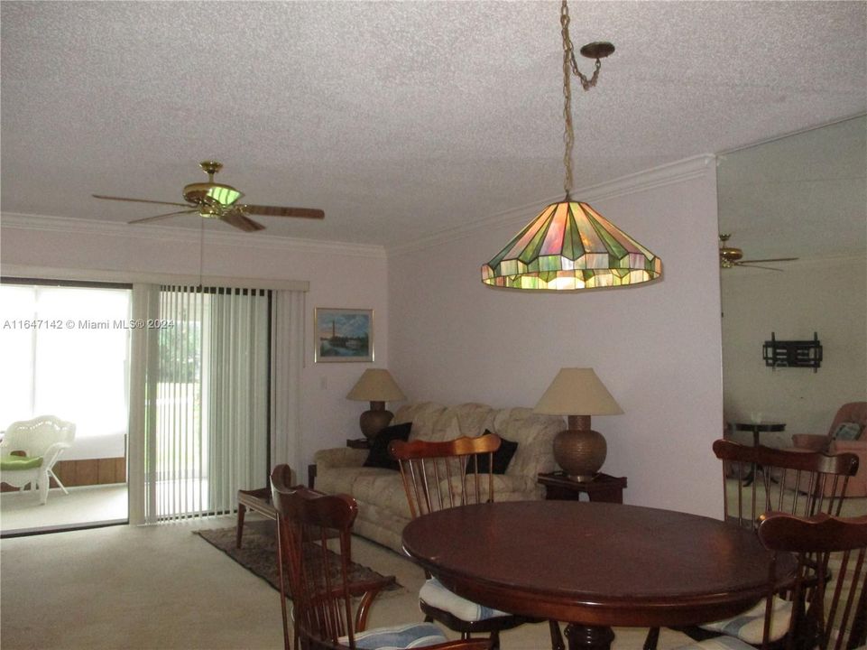 A VIEW FROM FRONT DOOR INTO LIVING/ DINING WITH SLIDING DOOR TO the PATIO