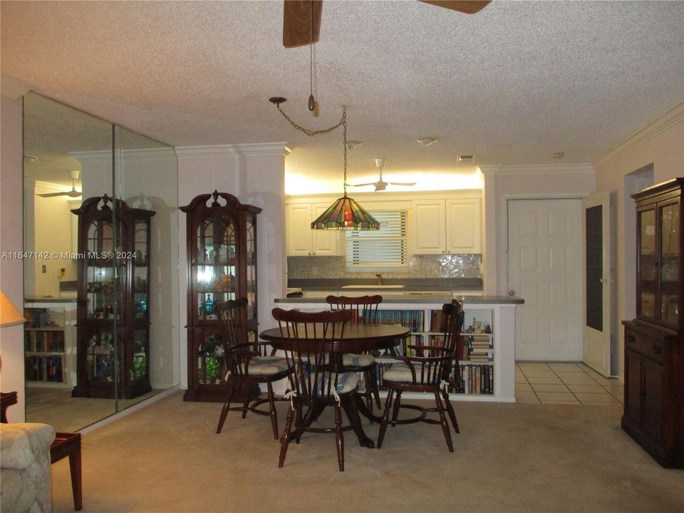 A VIEW FROM THE PATIO INTO THE DINING/LIVING & KITCHEN AREA