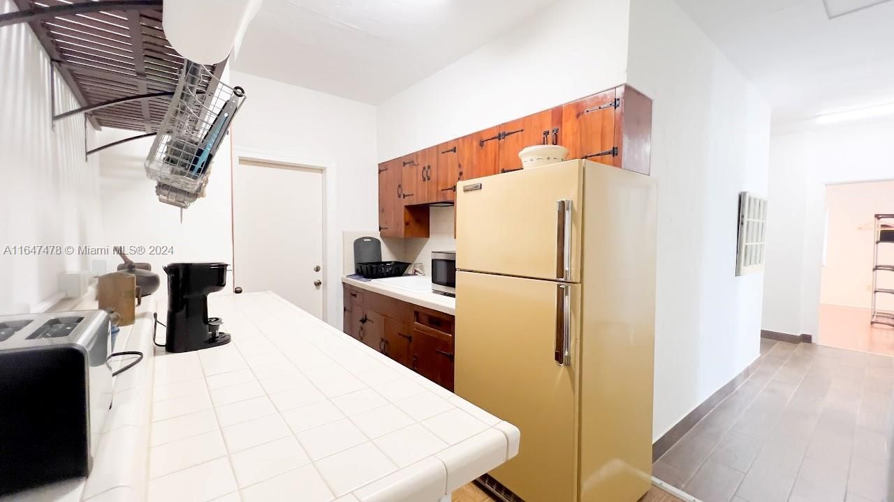 Kitchen with refrigerator.