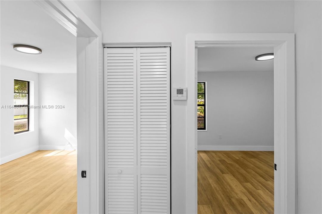 Hallway facing Bedroom #2 on the left, AC in the closet and Master Bedroom to the right