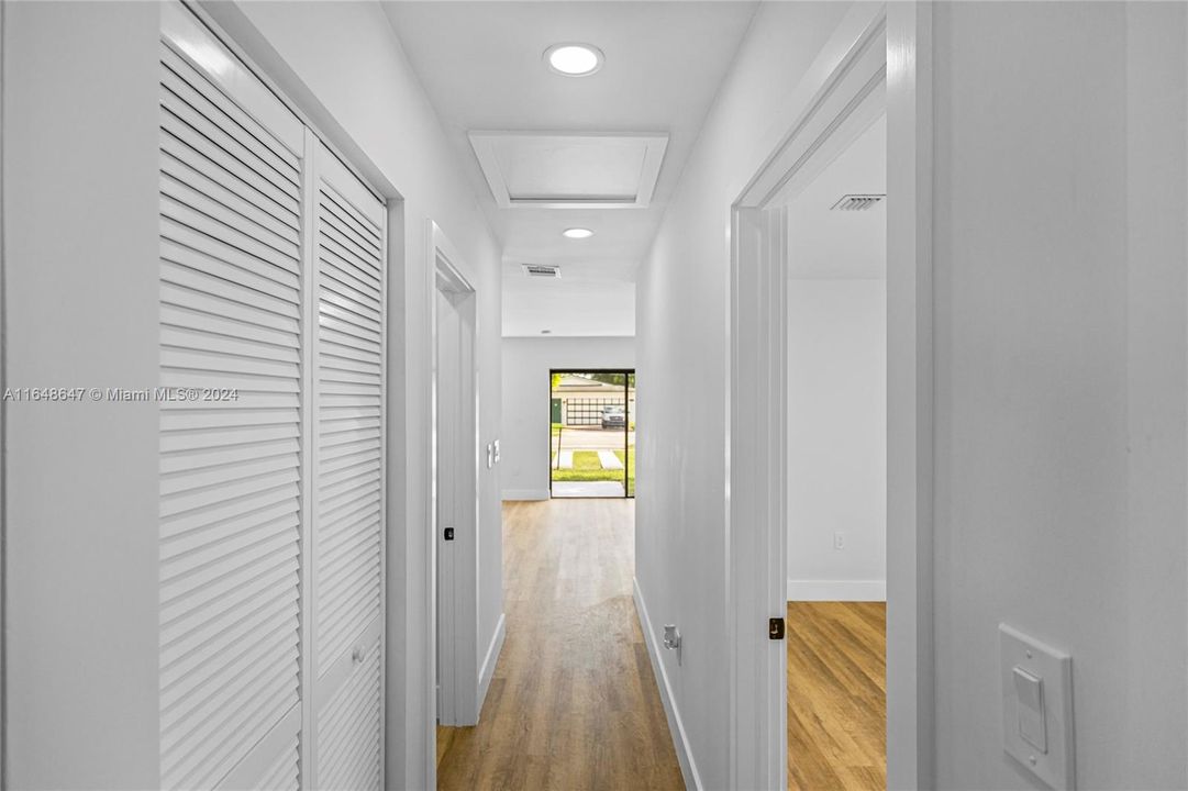 Hallway heading to the Kitchen & Living Area with Bedroom #1 on the right.