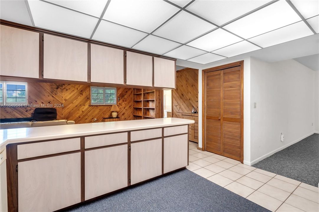 WOOD CABINETS AND CORIAN. EASY TO UPDATE  REMOVE UPPER CABINETRY CHANGES THE LOOK.