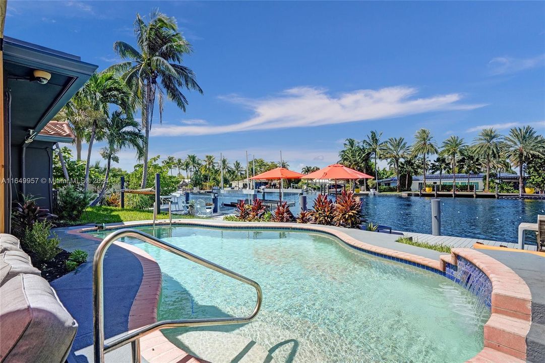 Relax and unwind in the saltwater pool, which overlooks the serene cove and open water, offering a picturesque and tranquil retreat.