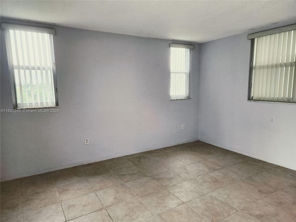 Bedroom 1 with windows, balcony and entrance to bathroom