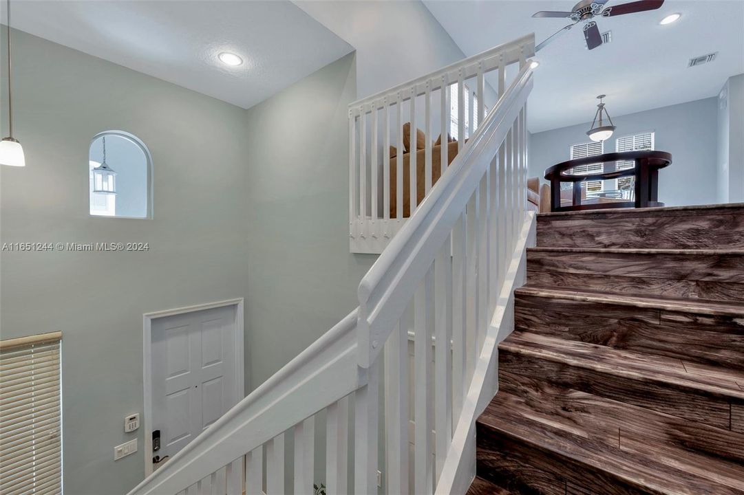 Stairs to living area, kitchen & bedrooms