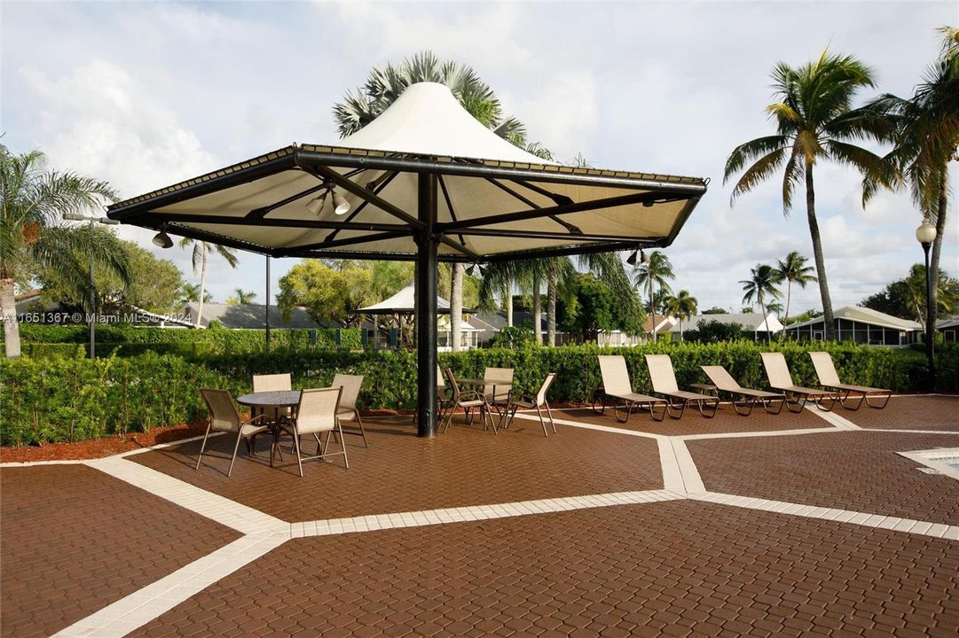 Plenty of shaded areas, chairs and lounge chairs by pool area