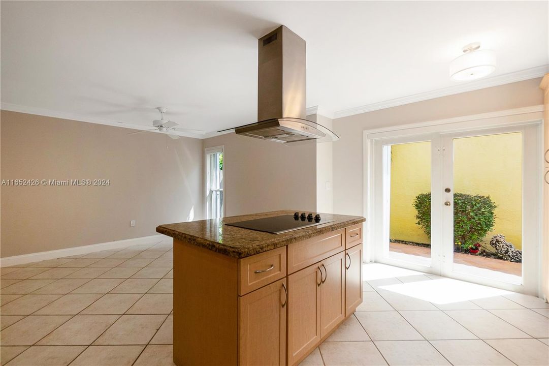 Kitchen has convenient double doors to the outside and easy entrance from the side door along the garage.