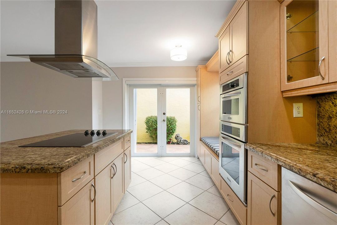 Kitchen has convenient double doors to the outside and easy entrance from the side door along the garage.