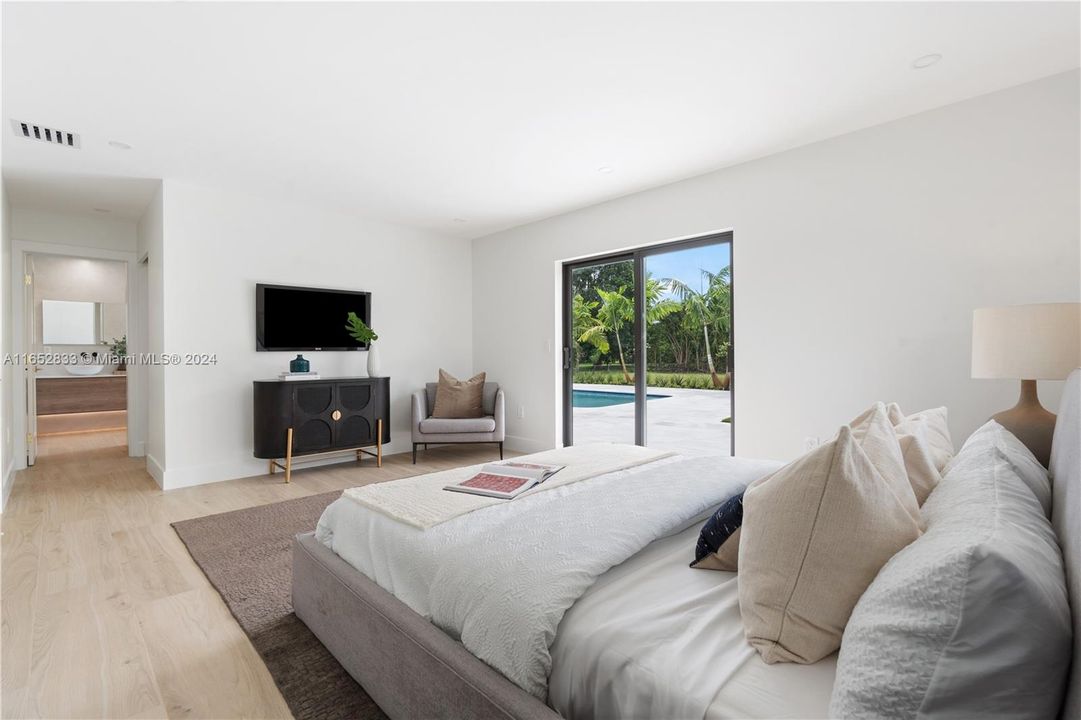 Master bedroom with sliding impact door to patio