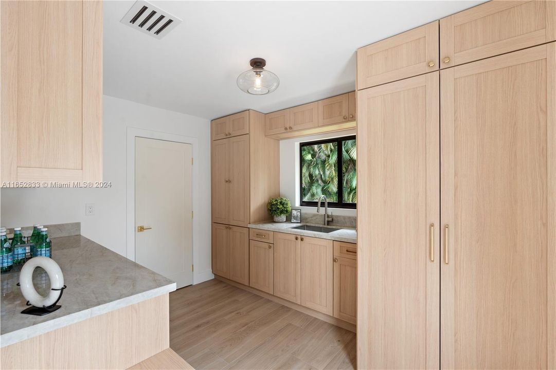 amazing custom built mudroom with laundry all hidden behind custom cabinets