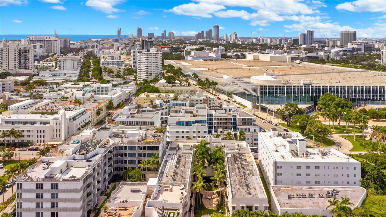 Stunning aerial view showcasing the resort-style building, lush courtyards, and surrounding Miami Beach landmarks.