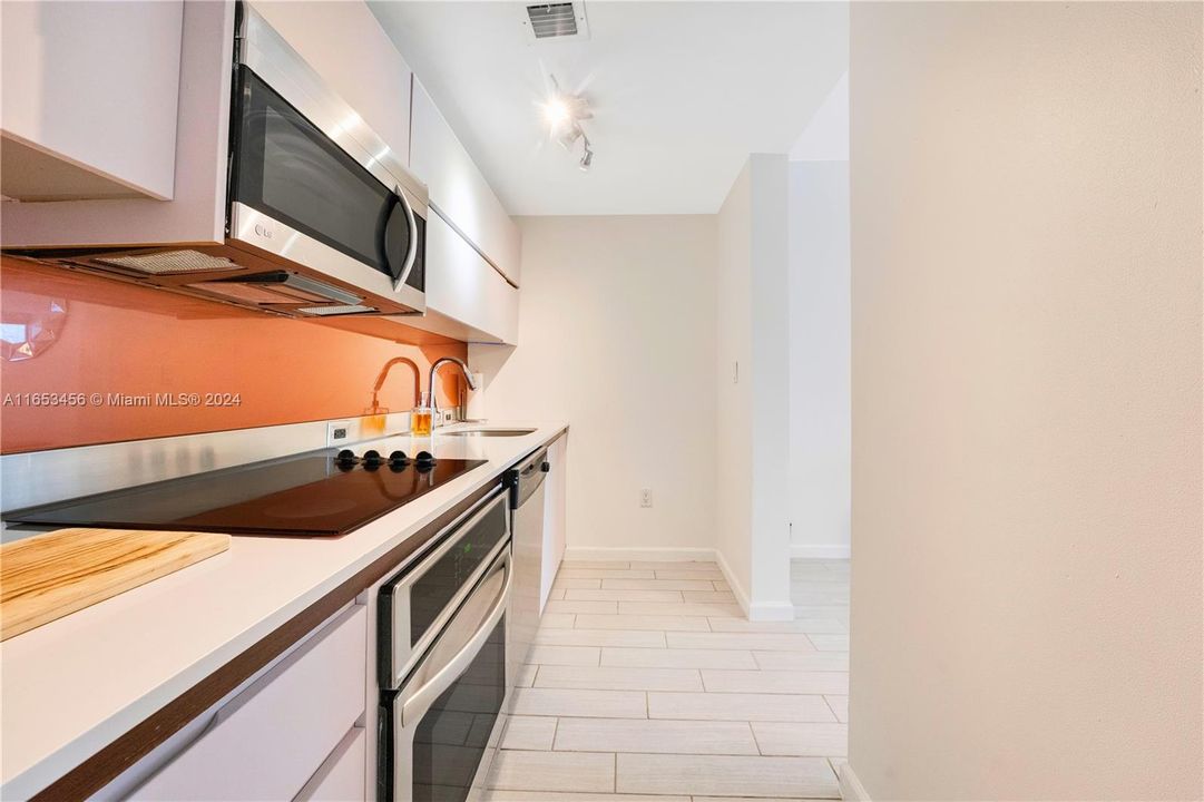 Well-designed kitchen with modern appliances and cabinetry, ideal for meal preparation and casual dining, blending seamlessly with the open living space.