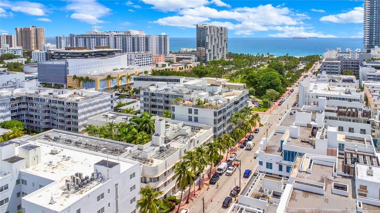 Stunning aerial view showcasing the resort-style building, lush courtyards, and surrounding Miami Beach landmarks.