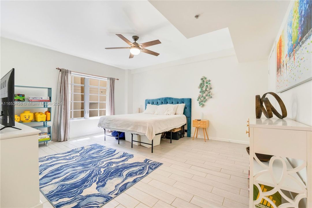 Large, sunlit bedroom with Eastern exposure, featuring a walk-in closet that provides ample storage.