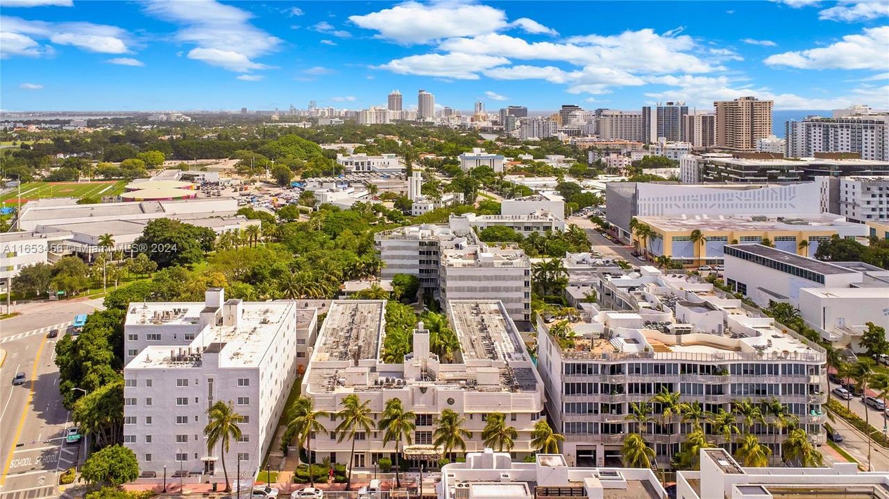 Stunning aerial view showcasing the resort-style building, lush courtyards, and surrounding Miami Beach landmarks.