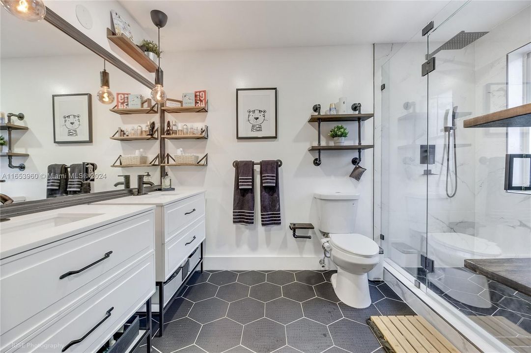 En suite Bathroom with double sinks and rainfall shower head.