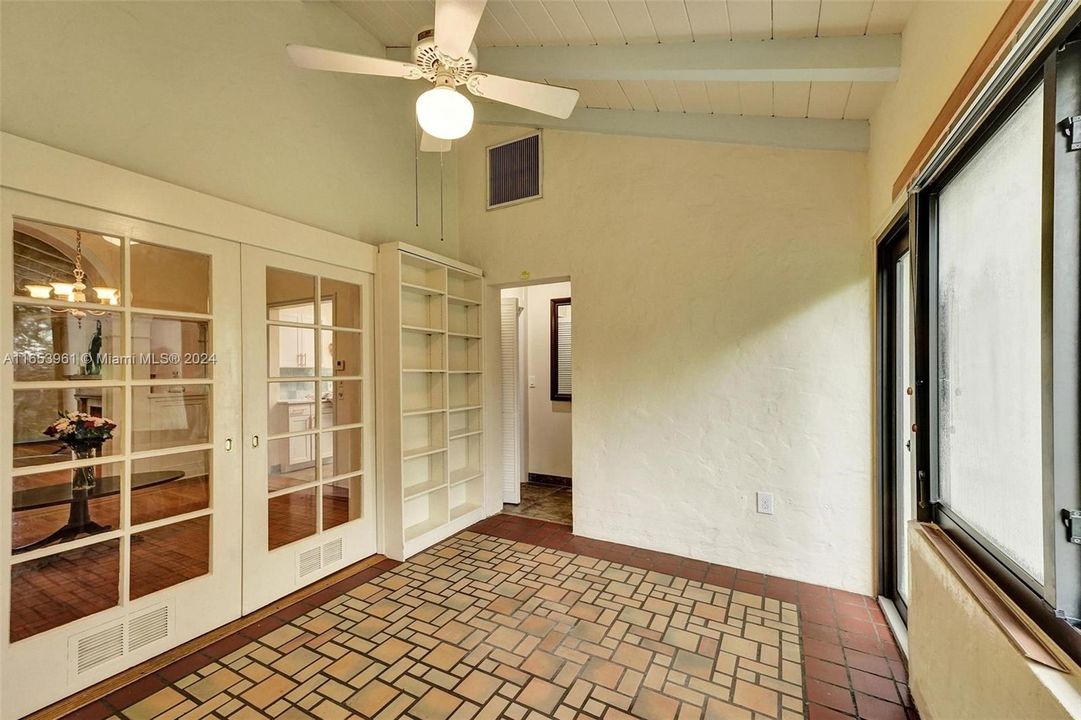 French door in Florida room with built in shelves