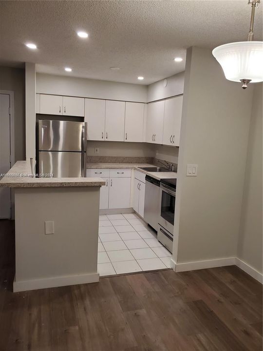 Second View of Updated Kitchen with Stainless Steel Appliances