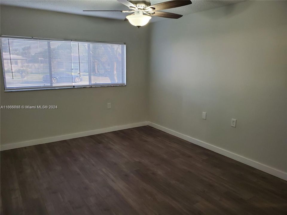 Partial View of Master Bedroom with New Wood Laminate Flooring