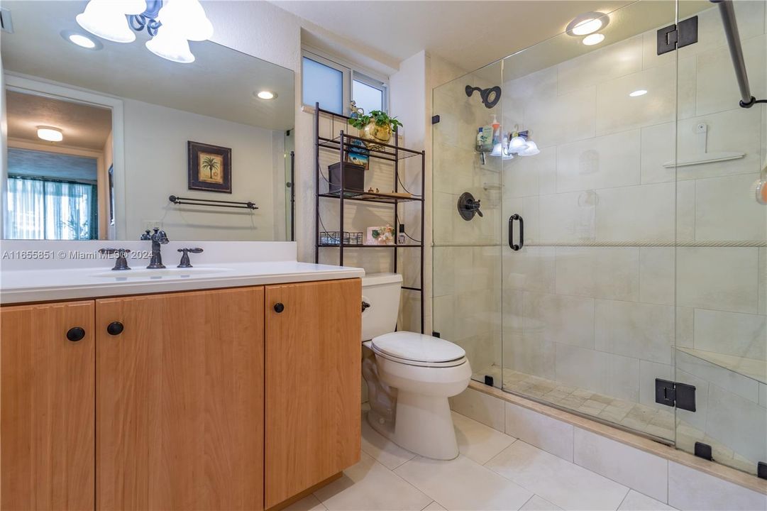 large bathroom with walk-in shower and glass enclosure