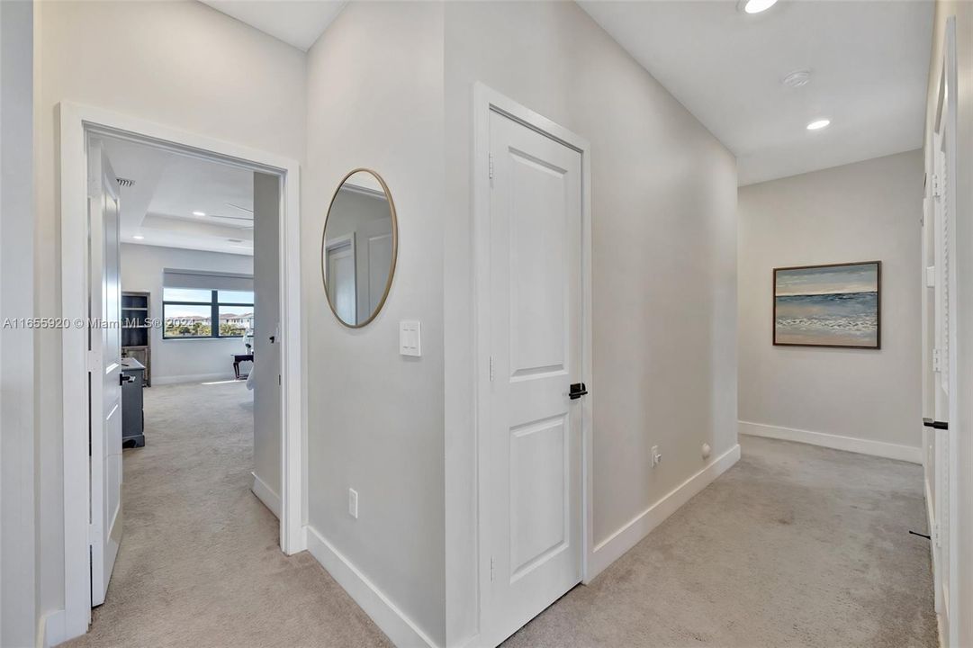 View toward primary bedroom. Other bedrooms down the hall