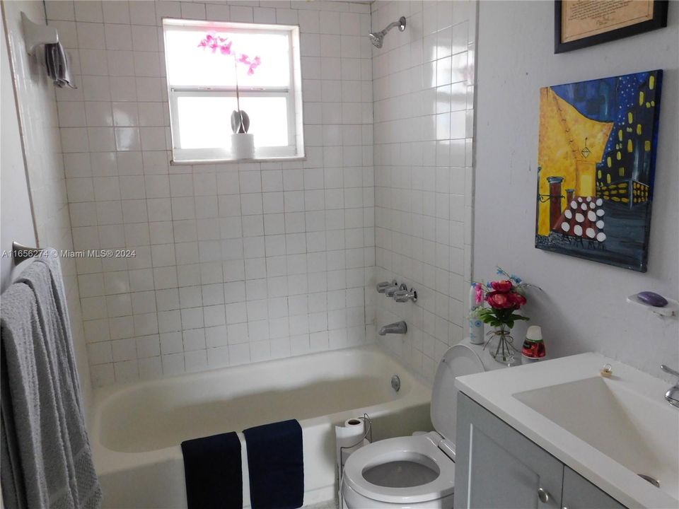 bathroom in hallway with new vanity and toilet