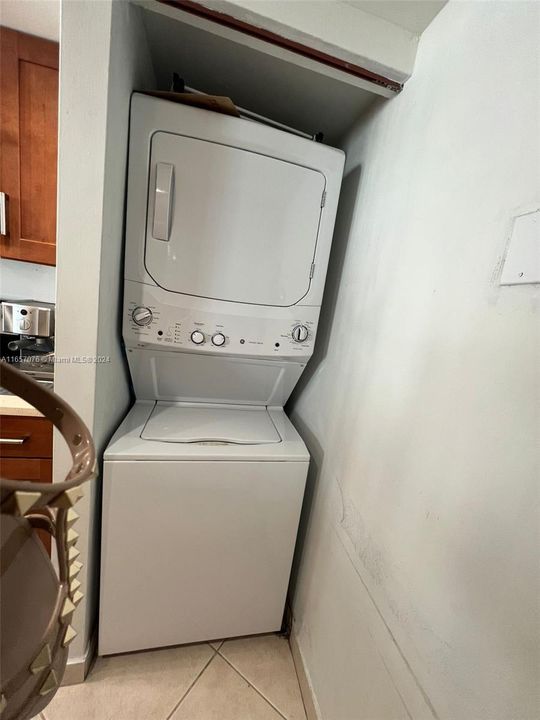 Washer/dryer located in the kitchen.