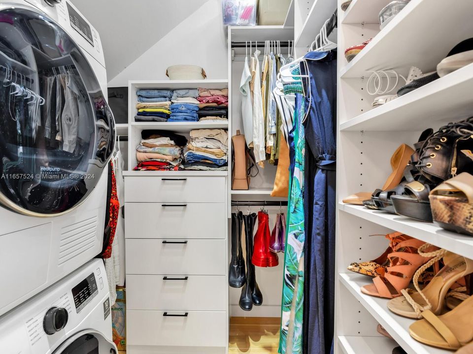 Walk-in Closet with California Closets Built-ins and Washer & Dryer