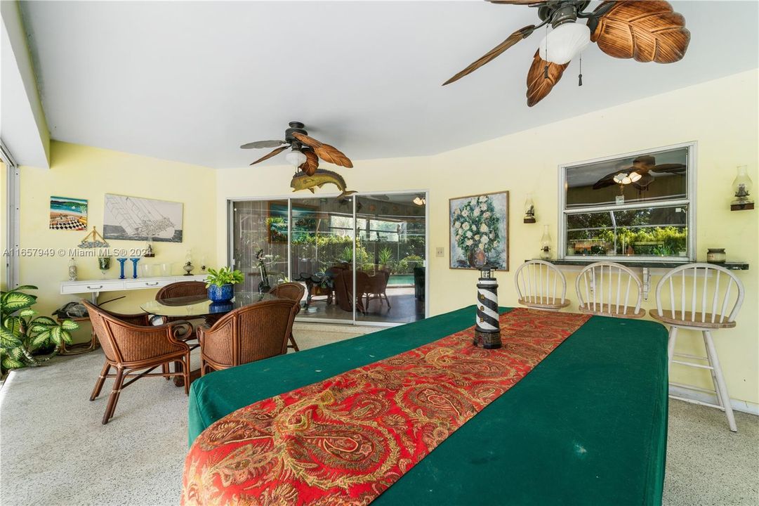 Covered area poolside. Sliding glass doors can be opened to allow easy flow from inside to outside