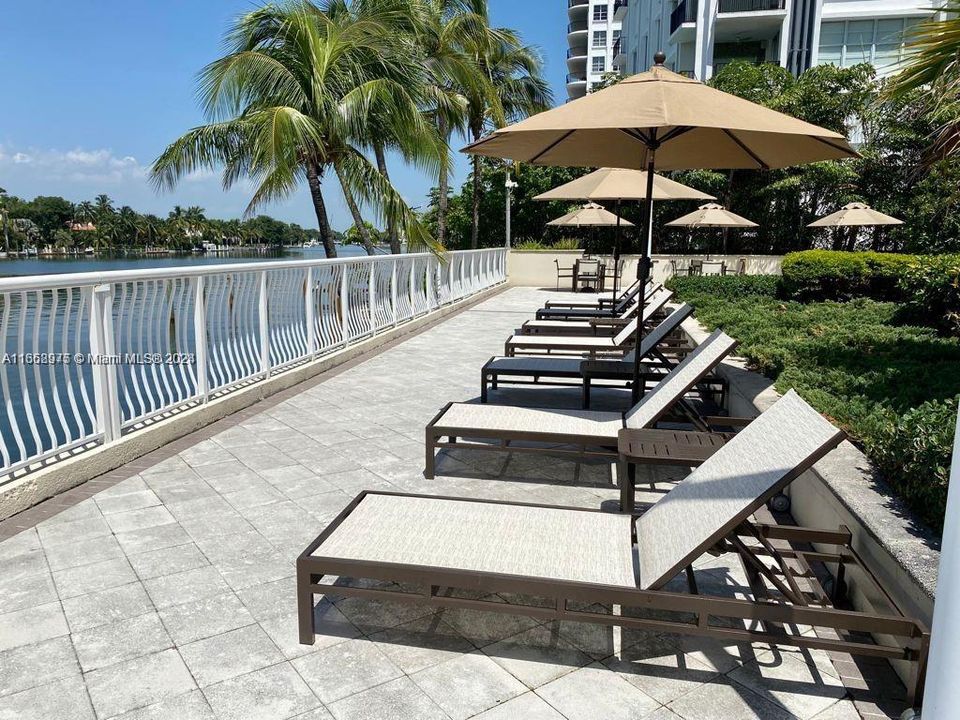 Lounge chairs in the pool area with water views