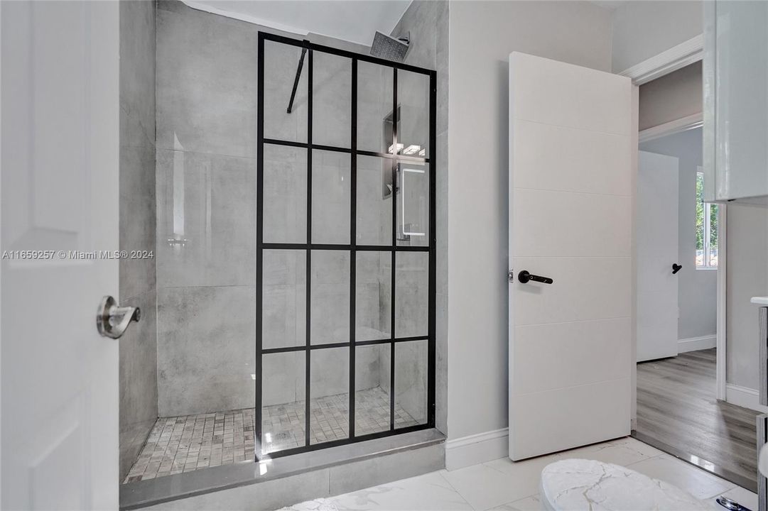 Modern rain shower with open enclosure.