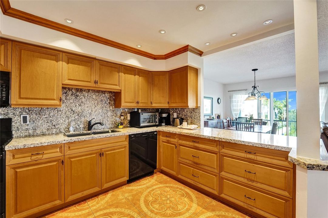 the kitchen opens to the dining area with plenty of storage