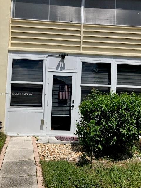 Impact Door leads directly into glass enclosed patio/office with path to your assigned parking spot