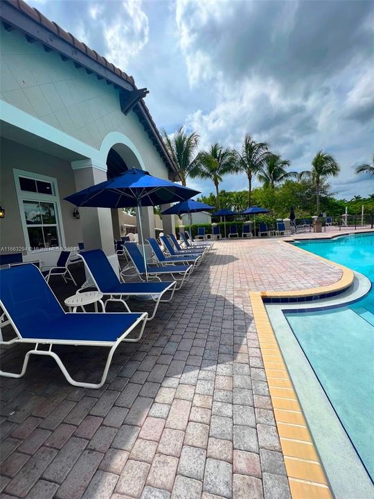 Plenty of poolside chairs & umbrellas