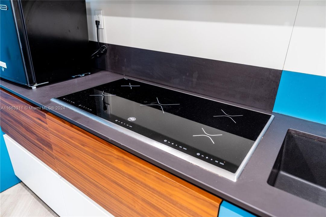 Induction cooktops and double ovens ovens, all in modern stainless steel