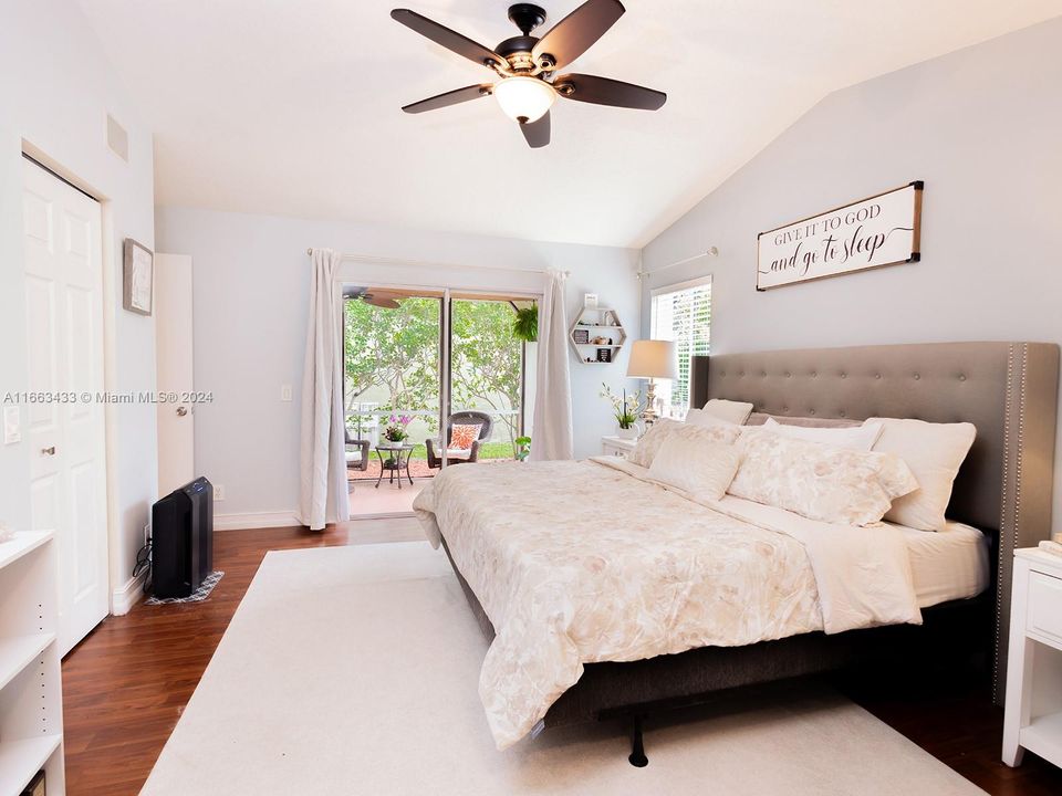 Master bedroom overlooking the screened in patio & private backyard