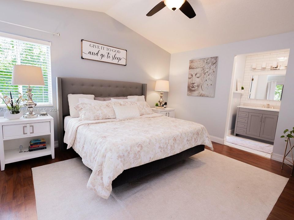 Master bedroom overlooking the screened in patio & private backyard