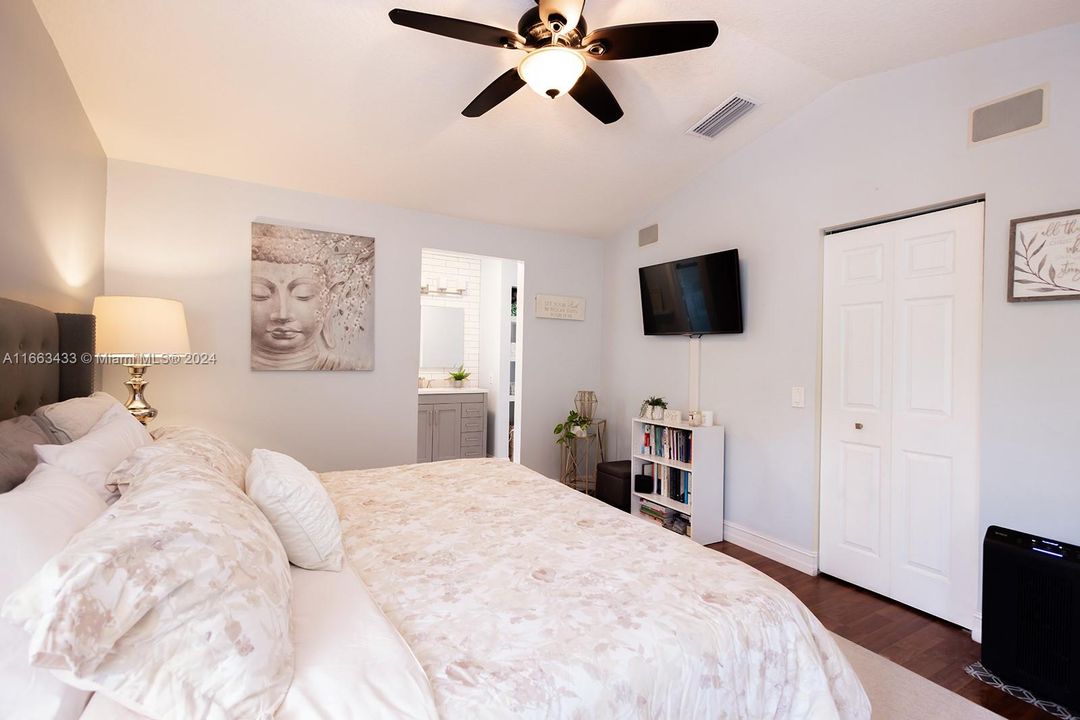 Master bedroom overlooking the screened in patio & private backyard