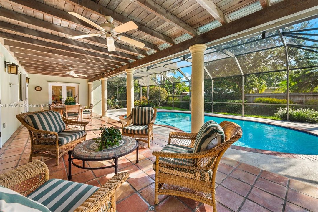 Relax under covered patio and screened pool