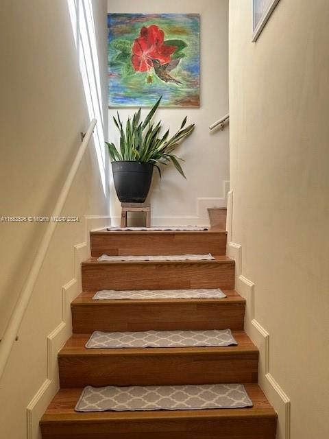 Front entrance interior stairs leading to main floor of unit